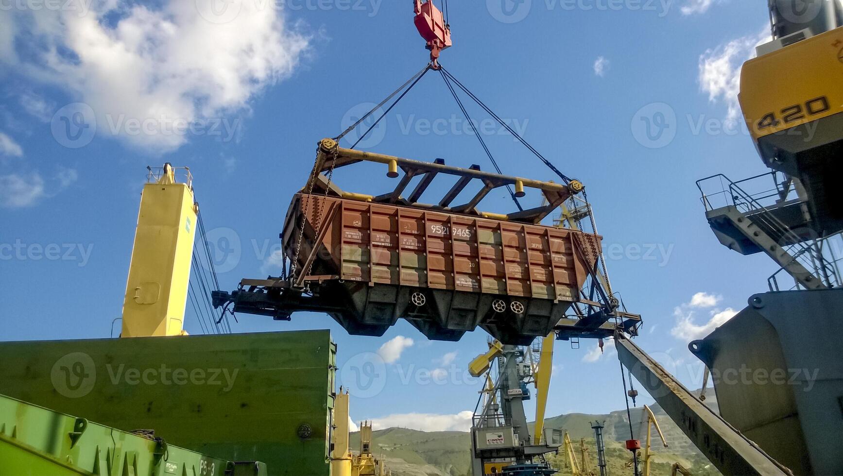 Industrial seaport. The rotation of the car with grain using a tower crane photo