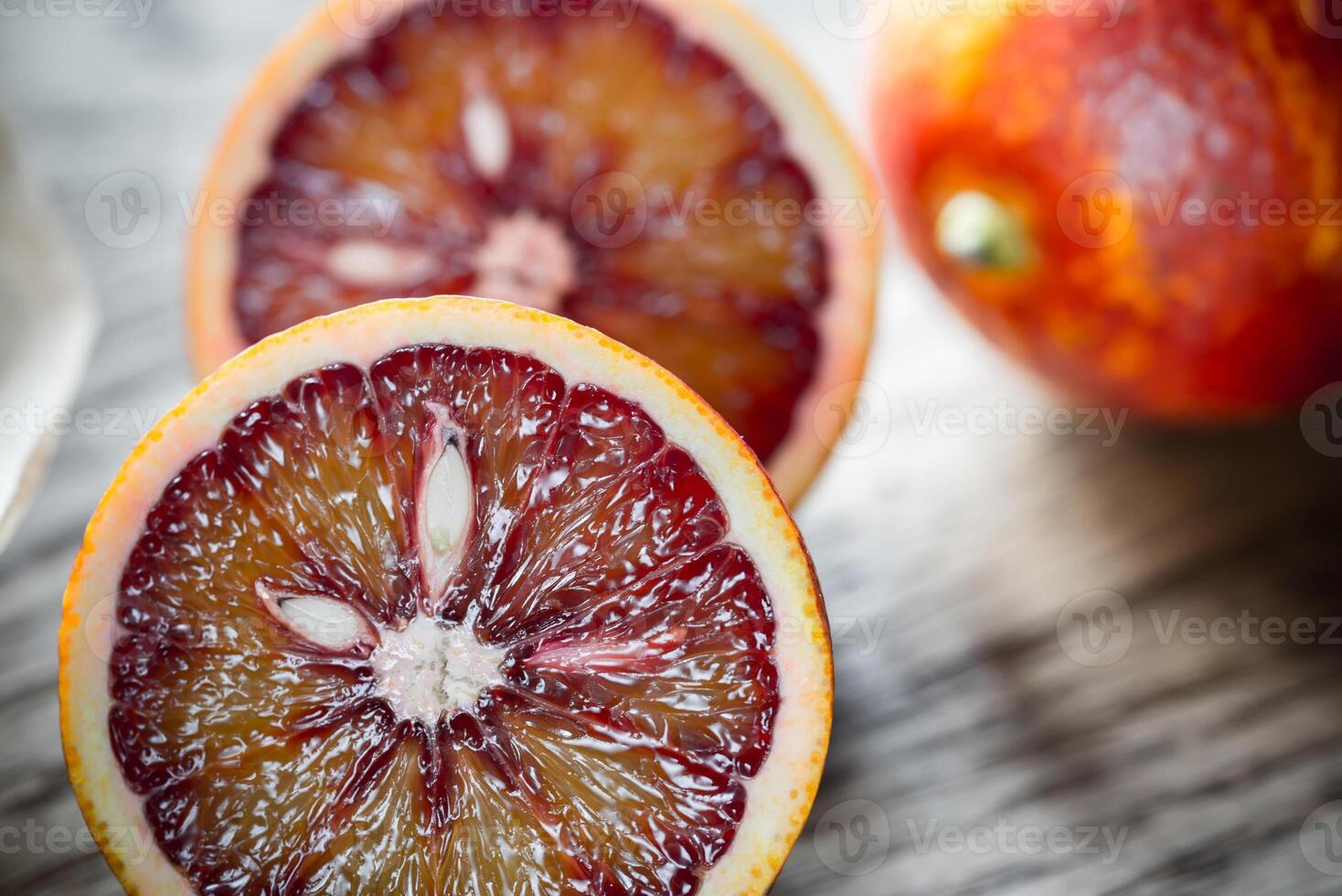 Red tangerines on the wooden background photo