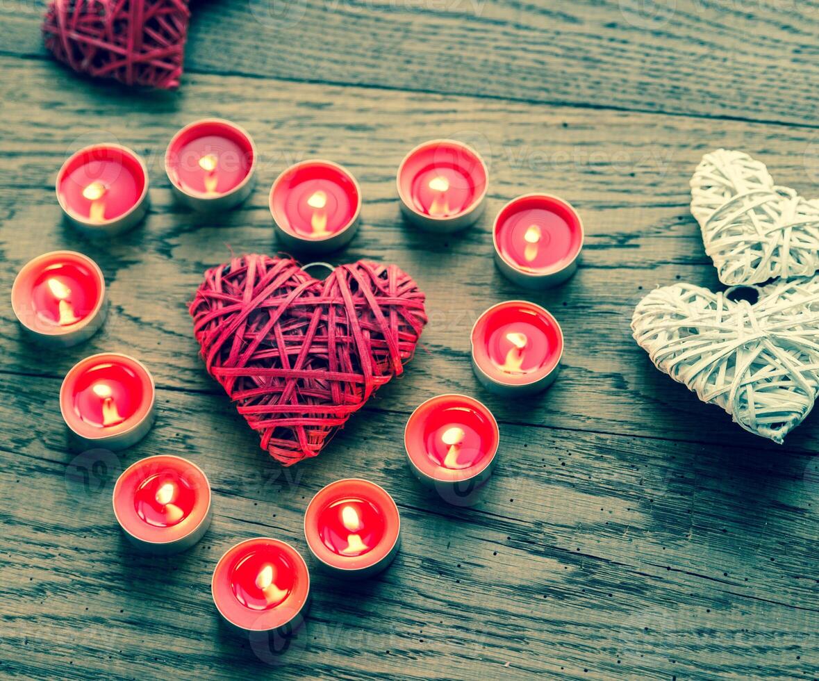 Burning candles with retro cane hearts photo