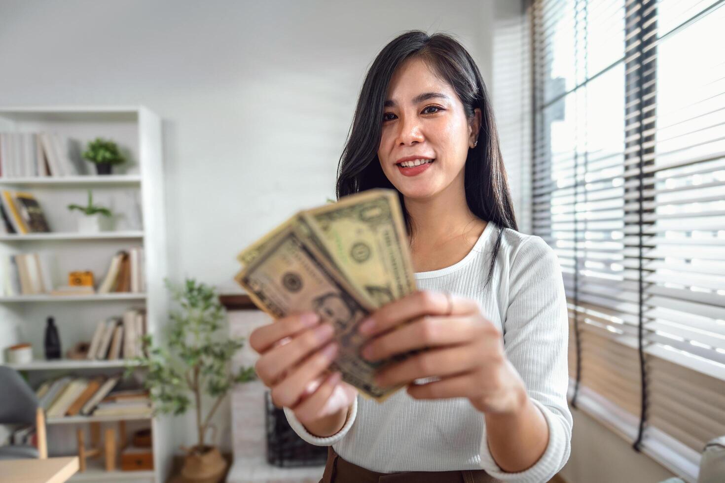 Portrait woman holding money banknotes. concept money saving photo