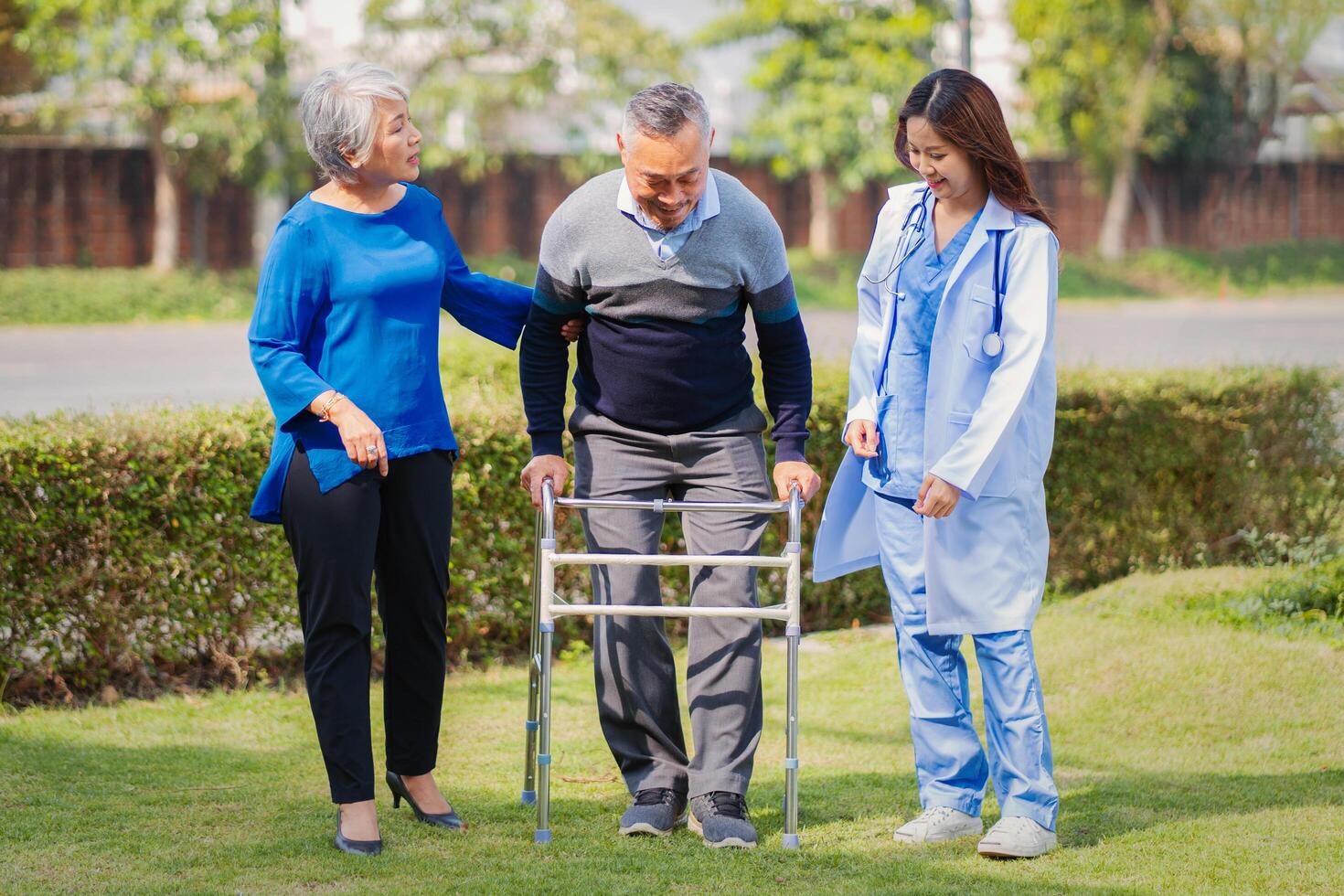 Senior man on wheelchair with doctor and wife photo