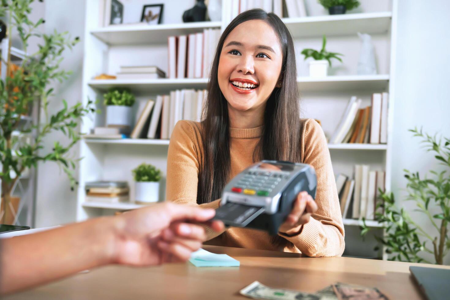 people paying bill with credit card by scanning on a card machine. Electronic payment photo
