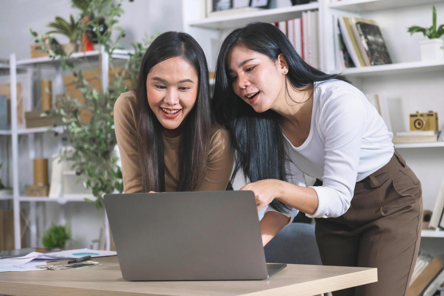 Accounting staff work together to exchange information on computers in the office photo