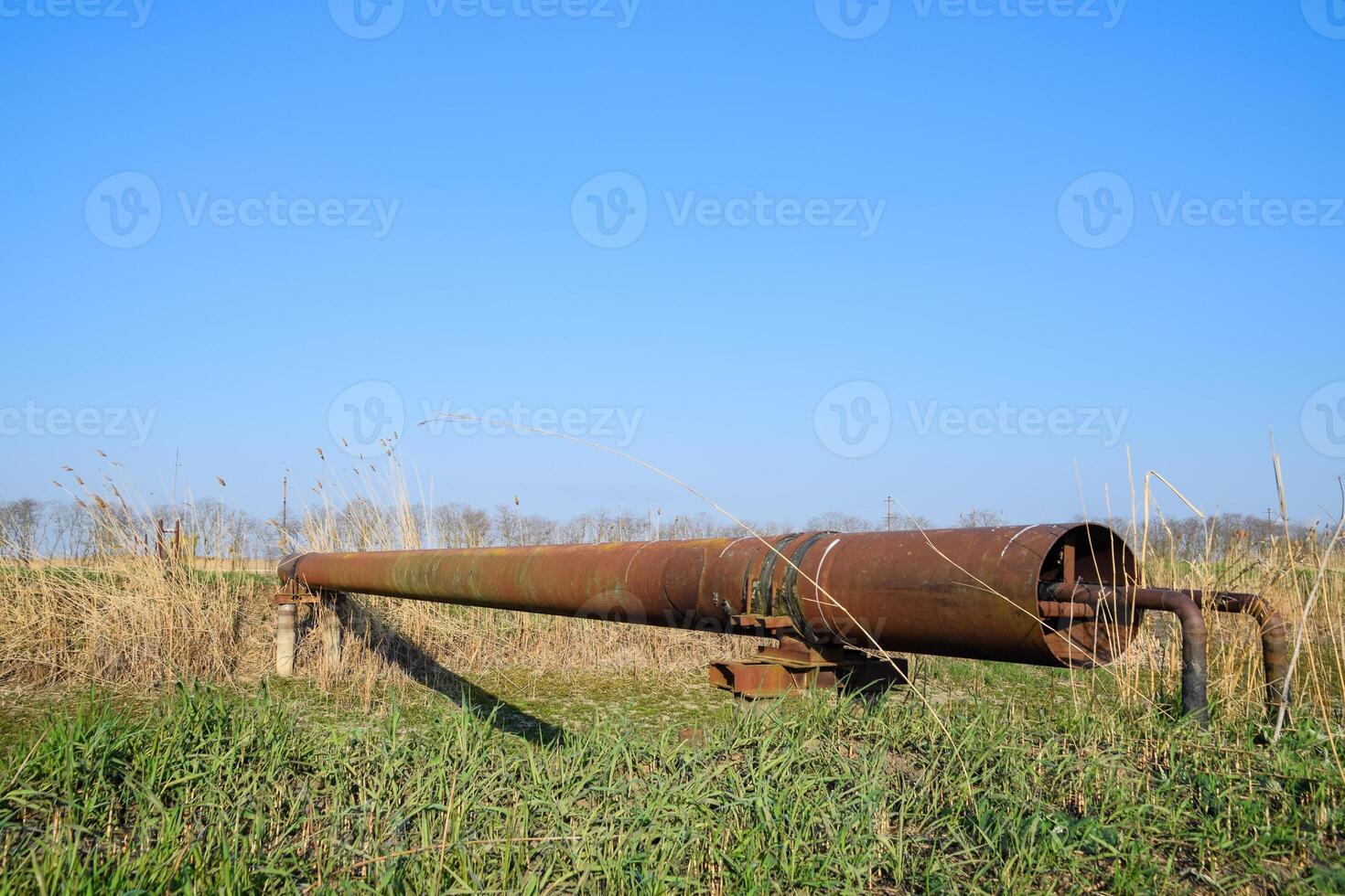 Gas pipeline through irrigation canal in a protective steel pipe. photo