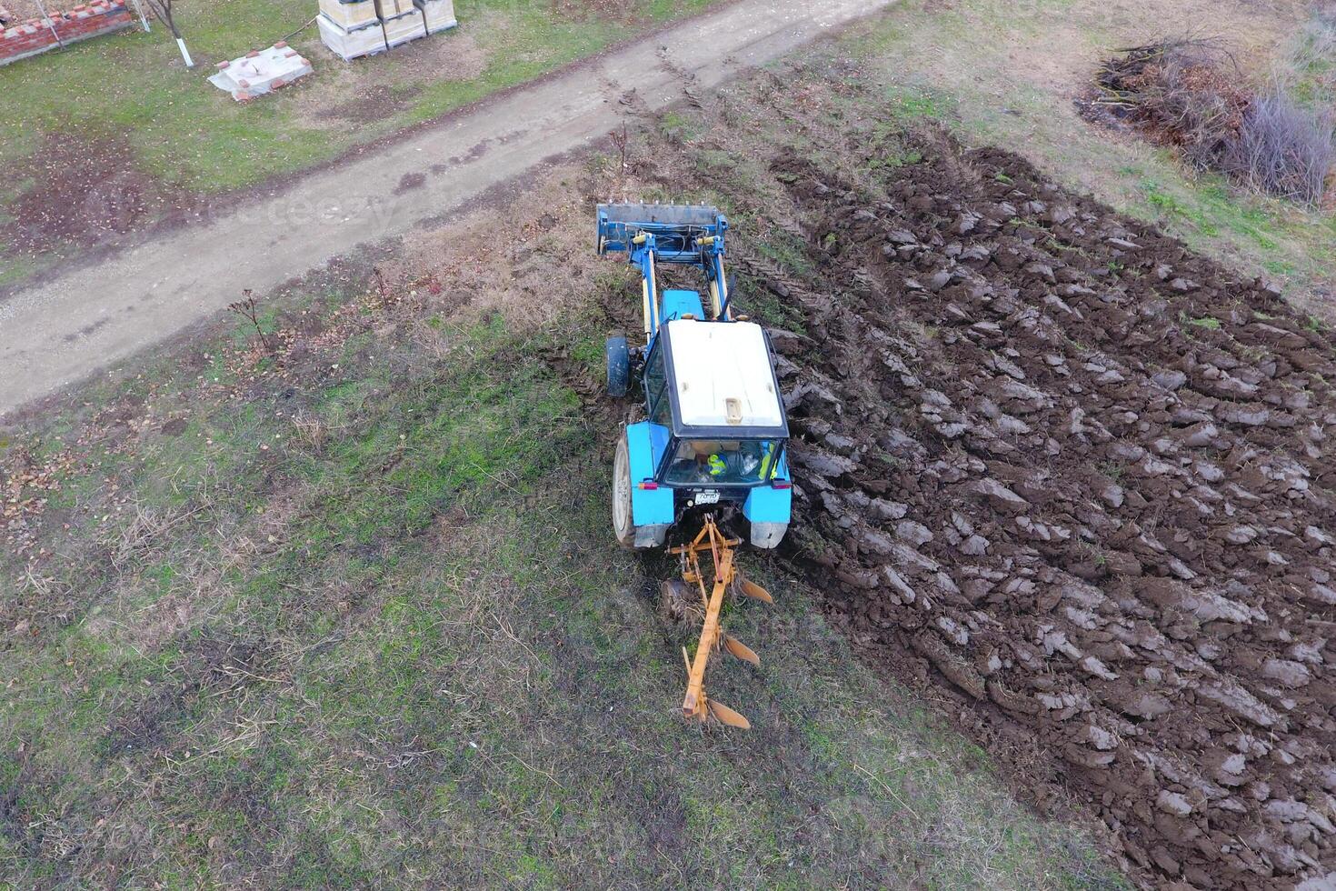 Tractor plowing the garden. Plowing the soil in the garden photo
