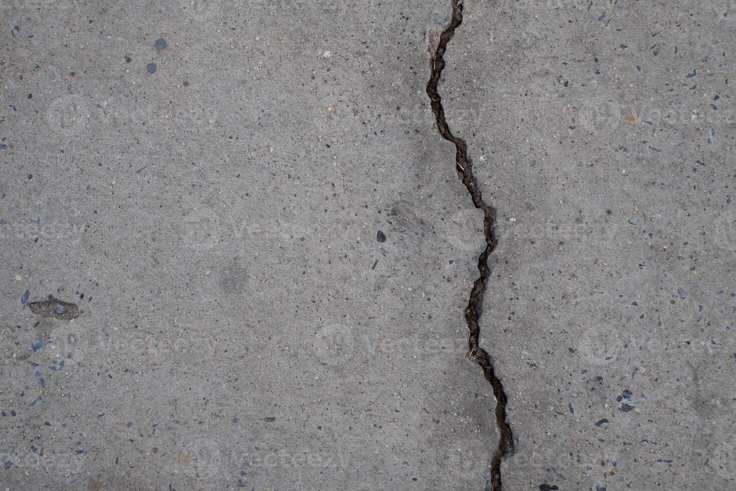 Cracked concrete wall broken wall at the outside cement corner that effected with earthquake and collapsed ground photo