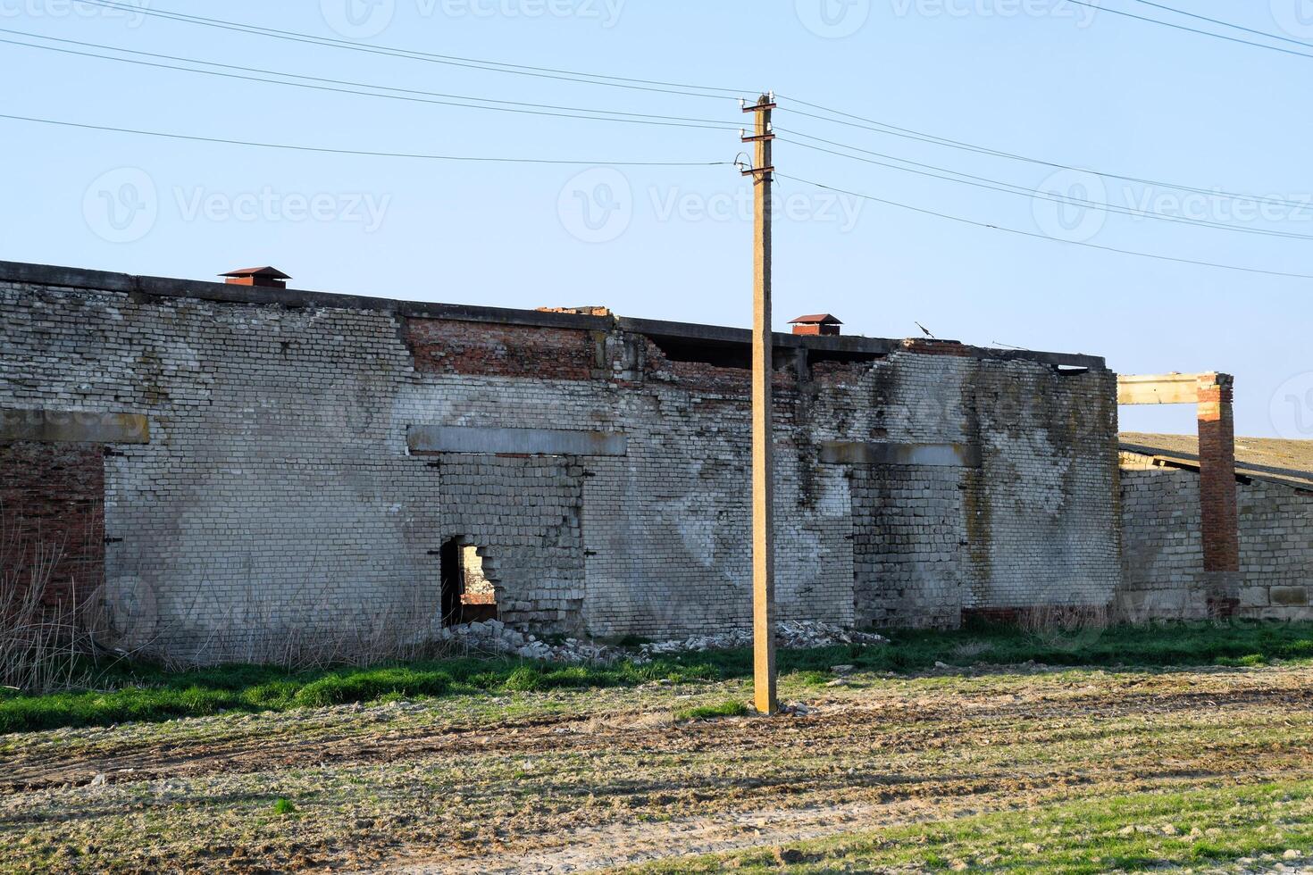 Old soviet brick abandoned building. Collapsing brick construction. photo