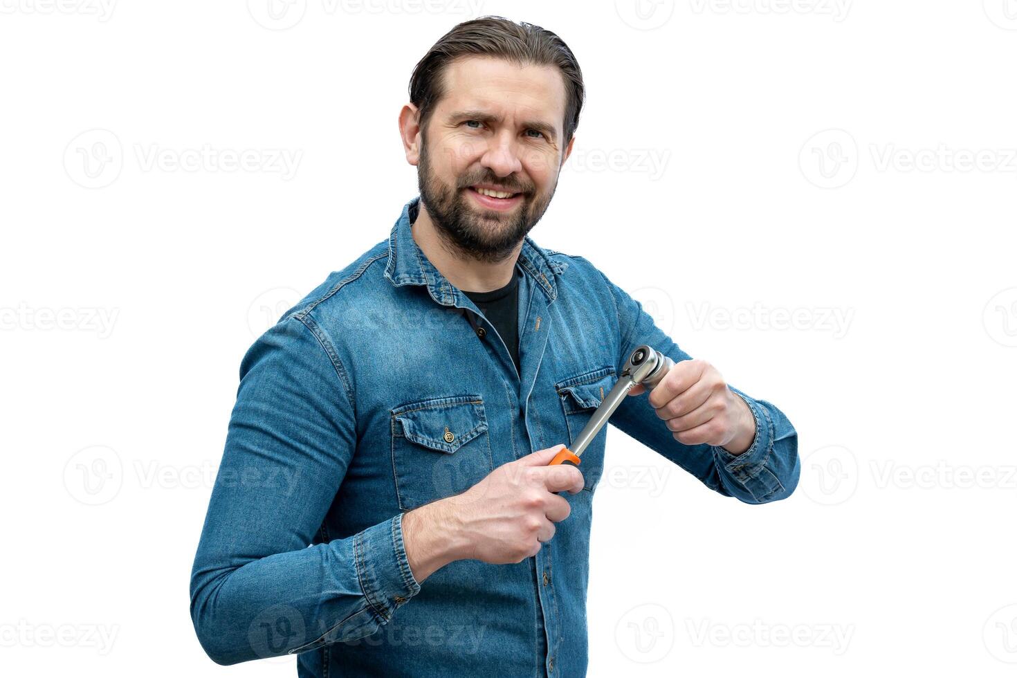 Automotive mechanic on white background holding a ratchet wrench. photo