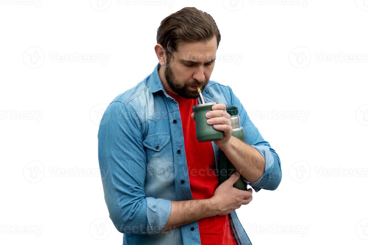 Casual young man drinking mates very seriously. photo
