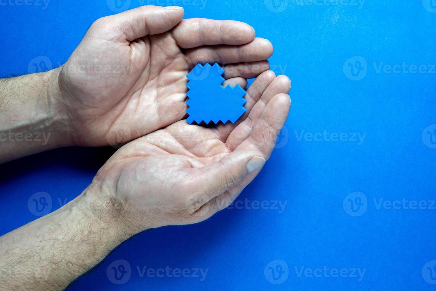 Blue Monday Concept. Hands of a man holding a blue heart. photo