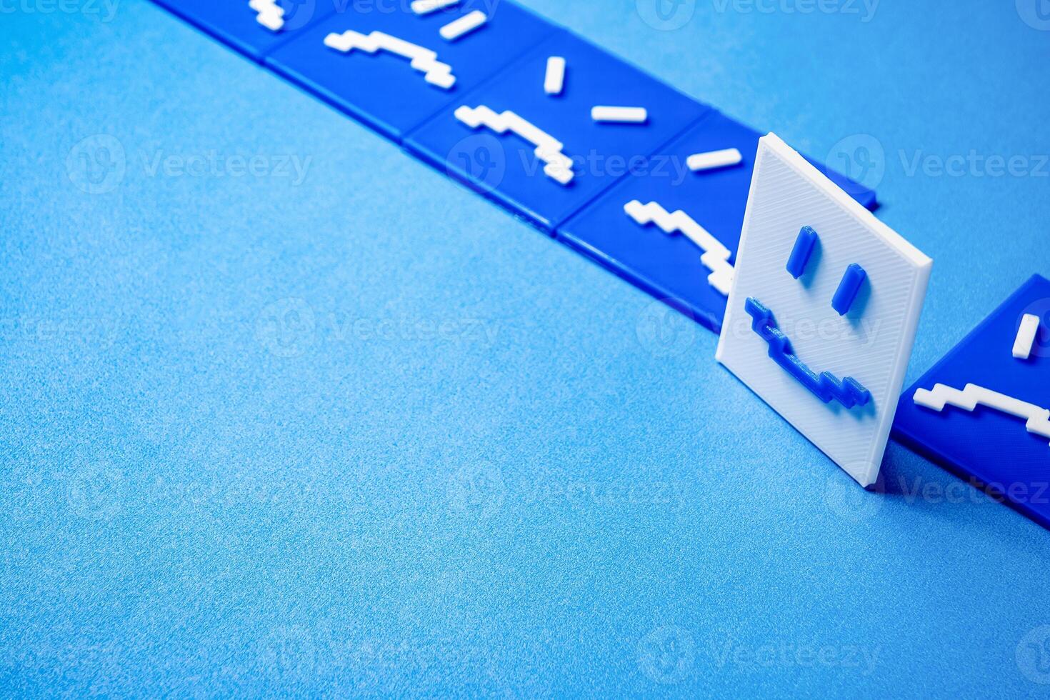 Concept of a happy face around sad and angry faces. photo