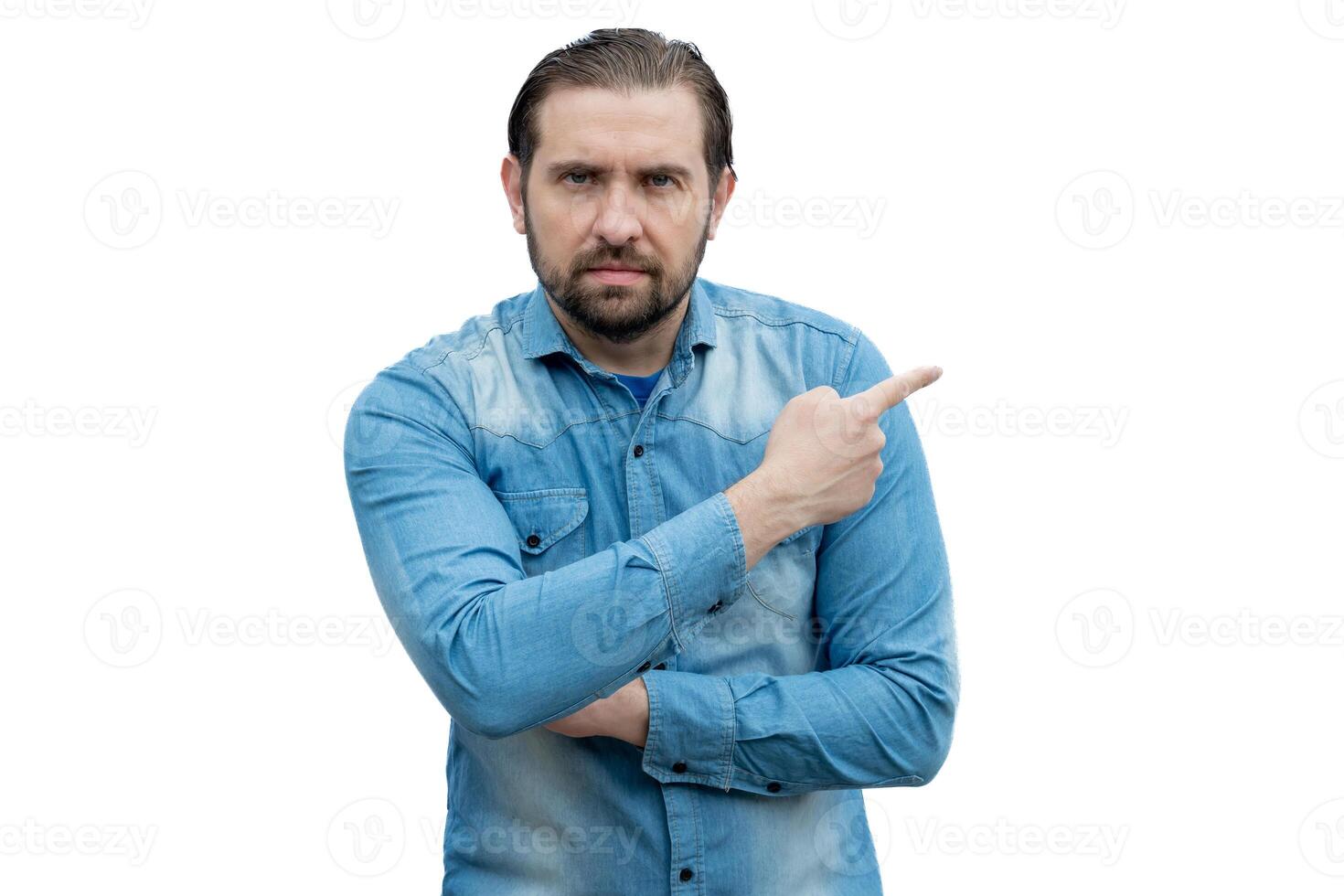 Caucasian man in jean shirt pointing to the side. photo