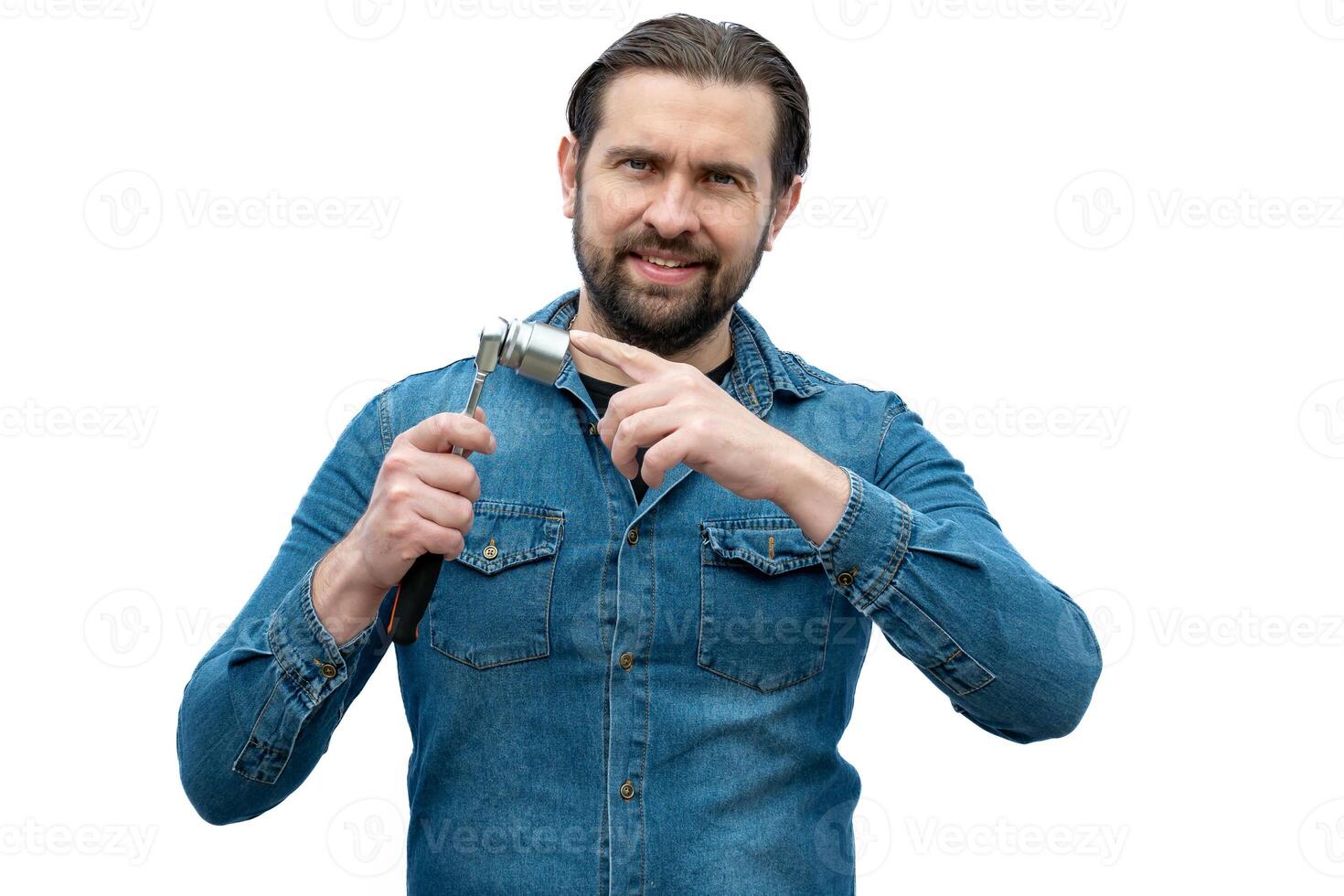 Young car mechanic holding a tool in his hands. photo
