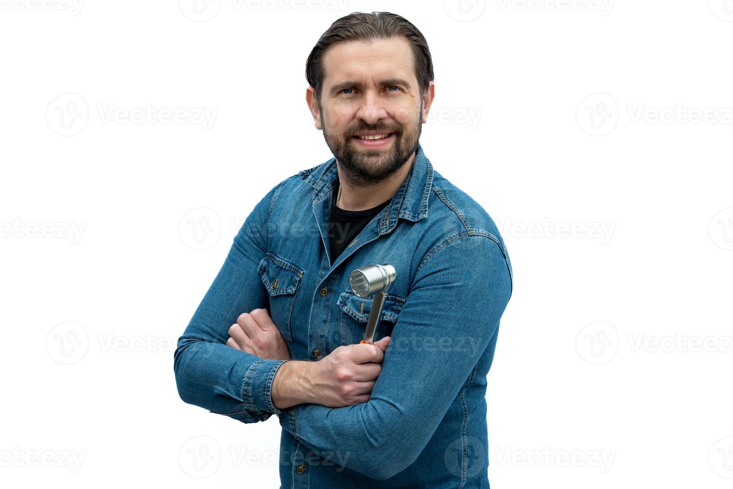 Mechanic posing for the camera crossing his arms. photo