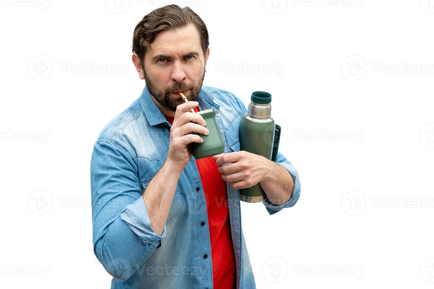 Young adult Argentinian man drinking mate. photo