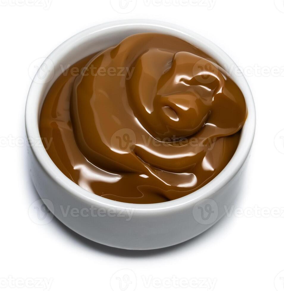 Dulce de leche in a small bowl on isolated background. photo
