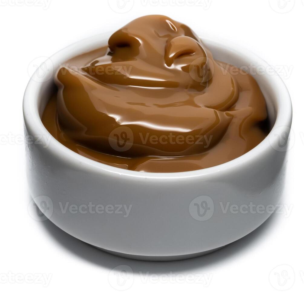 Dulce de leche in a small bowl on isolated background. photo