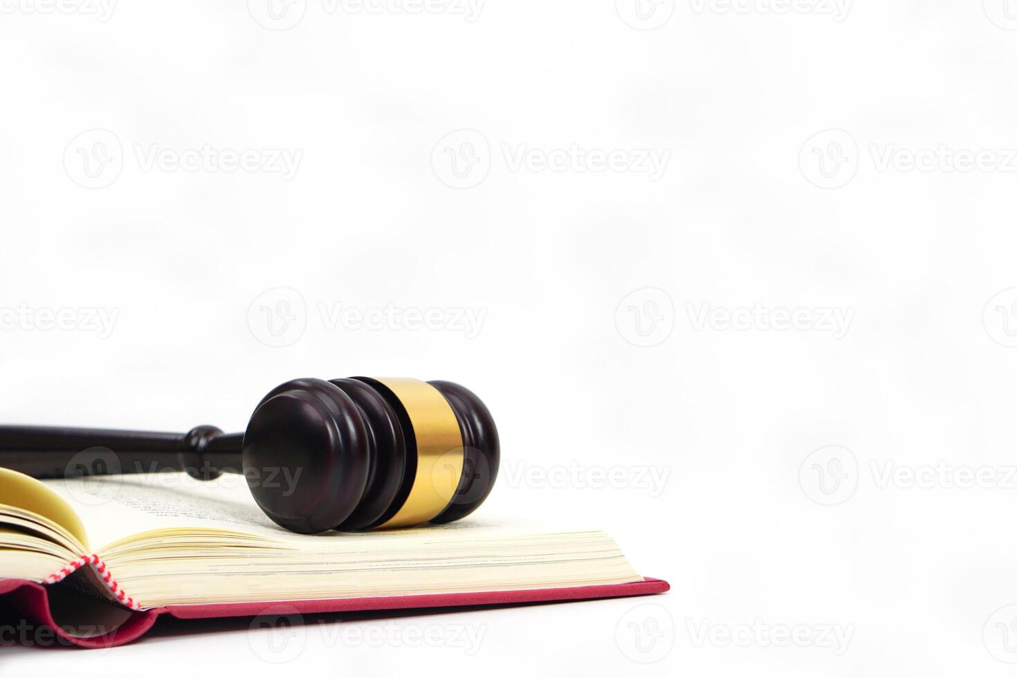 Gavel of judge placed on law book on white background. Law, lawyer, legal, judiciary concept. photo