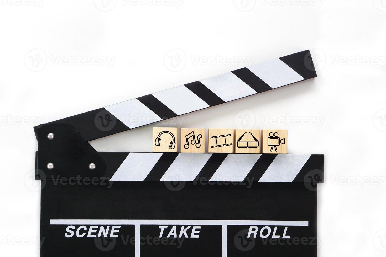 Clapperboard or movie slate black color on white background and various entertainment icons on wooden blocks. Cinema industry, video production and film concept. photo