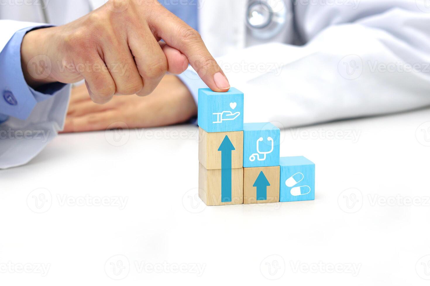 Finger of doctor touching a wooden block cube with medical icon symbol. Medical, health and insurance concept. photo