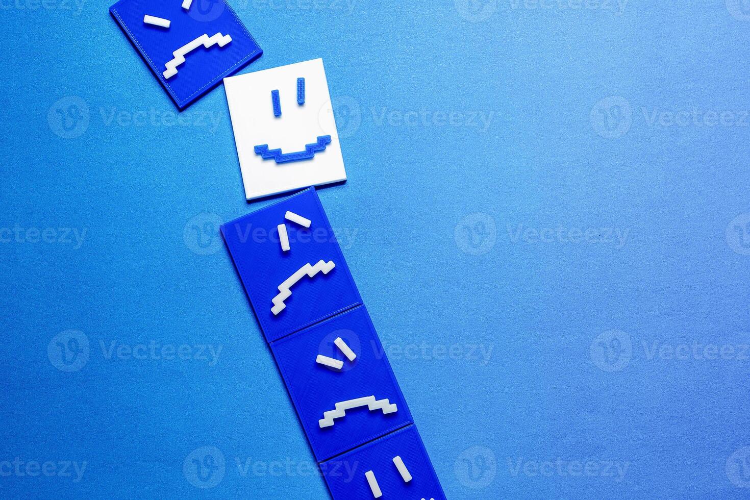 Concept of a happy face around sad and angry faces. photo