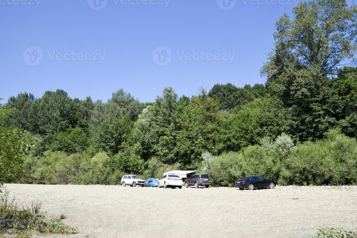 Camping in nature. Departure by car to the nature to the river in the forest. photo