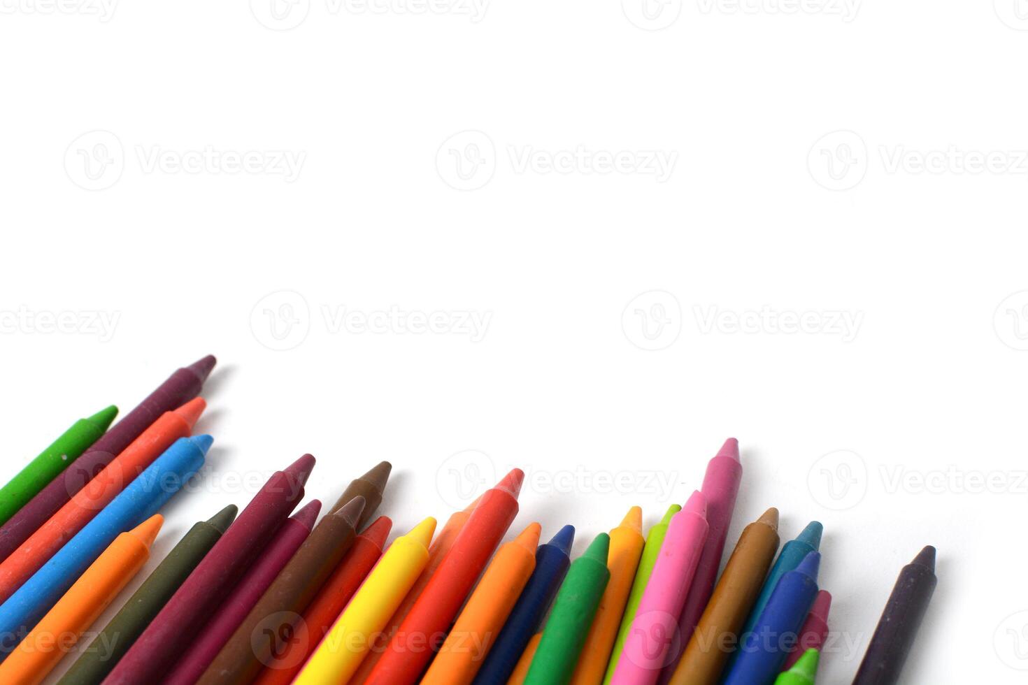 Crayons lined up isolated on white background. photo