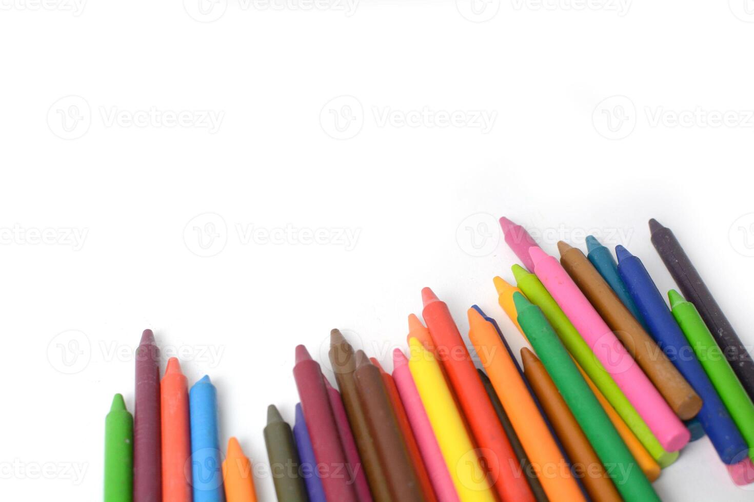 Crayons lined up isolated on white background. photo