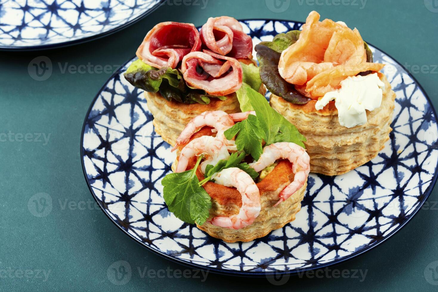 Tartlets, canapes with smoked salmon, shrimp and bacon. photo