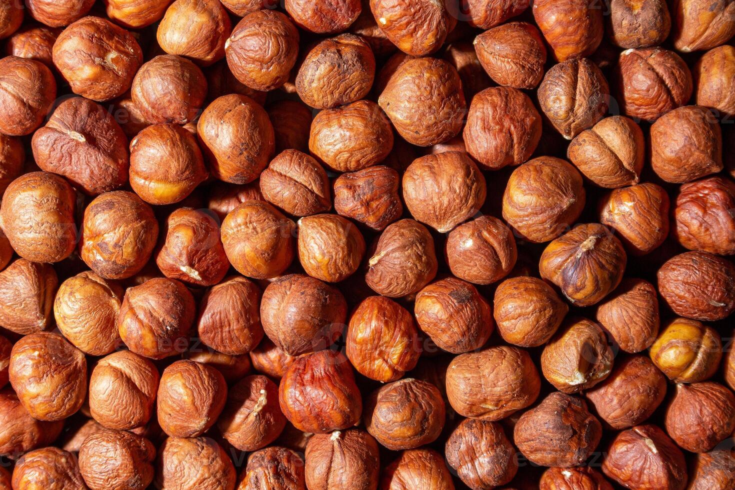 Scattered Peeled Hazelnut - Top View. Background from Hazelnuts. Natural High-Calorie Snacks photo