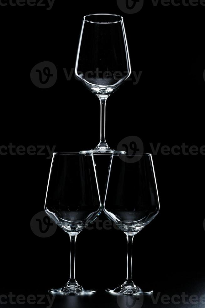 silhouette of wine glass bottle full of smoke in black background photo