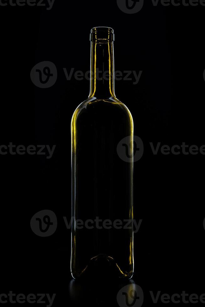 silhouette of wine glass bottle full of smoke in black background photo