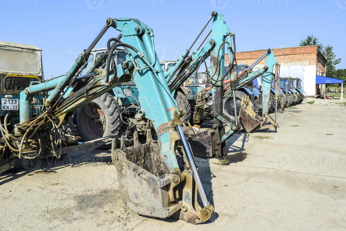 Tractor with a bucket for digging soil. Bulldozer and grader. photo