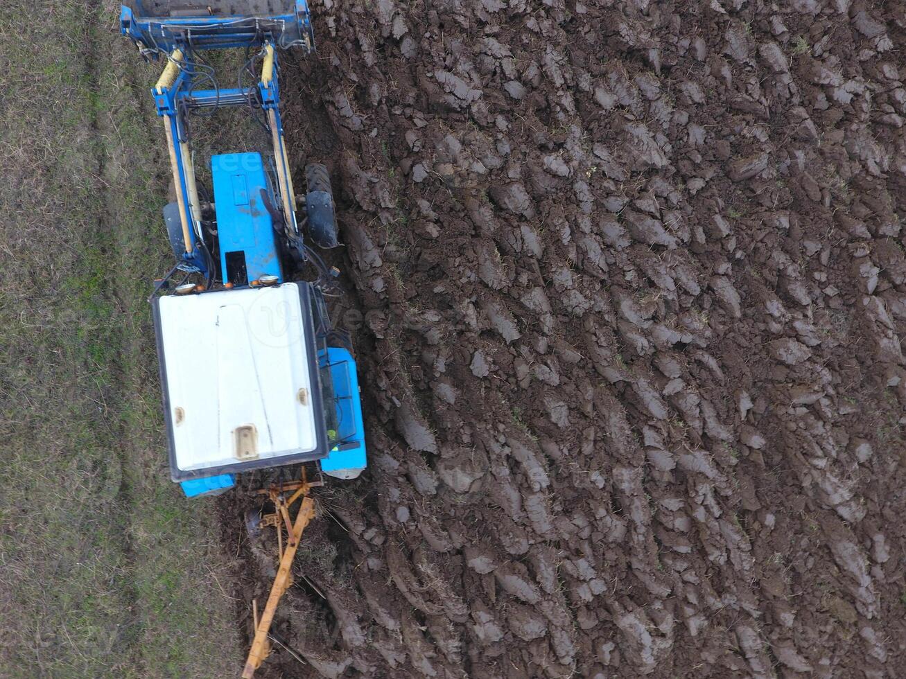 Tractor plowing the garden. Plowing the soil in the garden photo