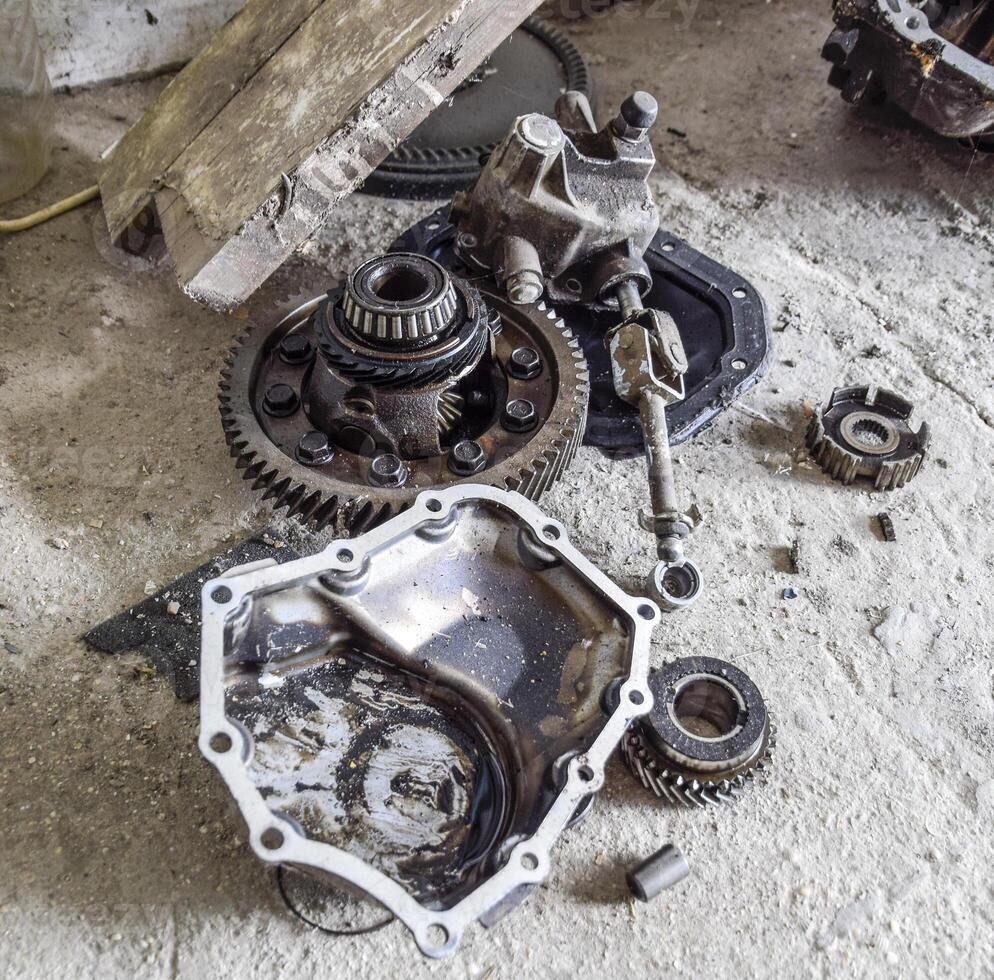 Dismantled box car transmissions. Gear with bearings and gearbox housing. The gears on the shaft of a mechanical transmission. photo
