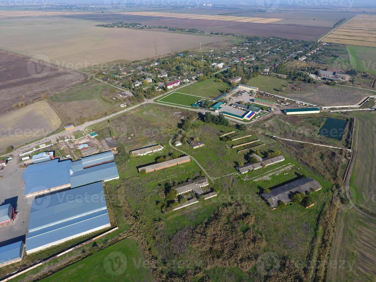 Top view of the village. One can see the roofs of the houses and gardens. Top view of the village with houses and hangars for the storage of grain. photo