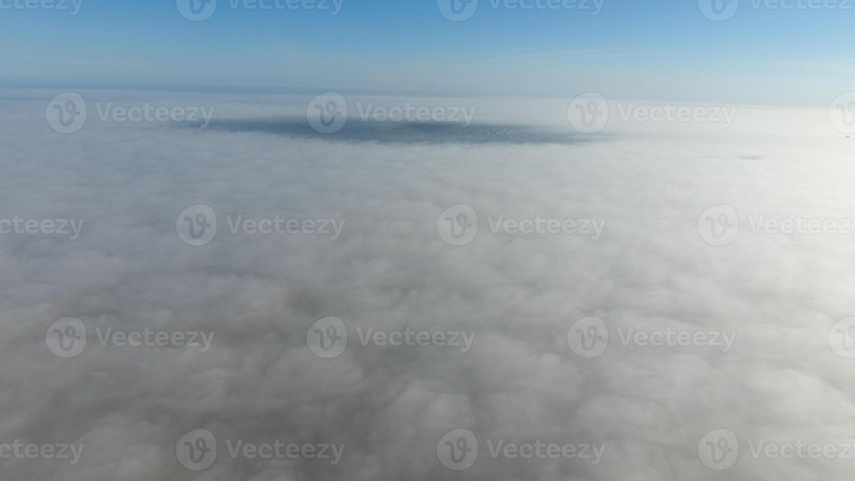 Fog above the ground. Top view of the fog. Low clouds. Morning mist condensation. Shooting with a drone photo