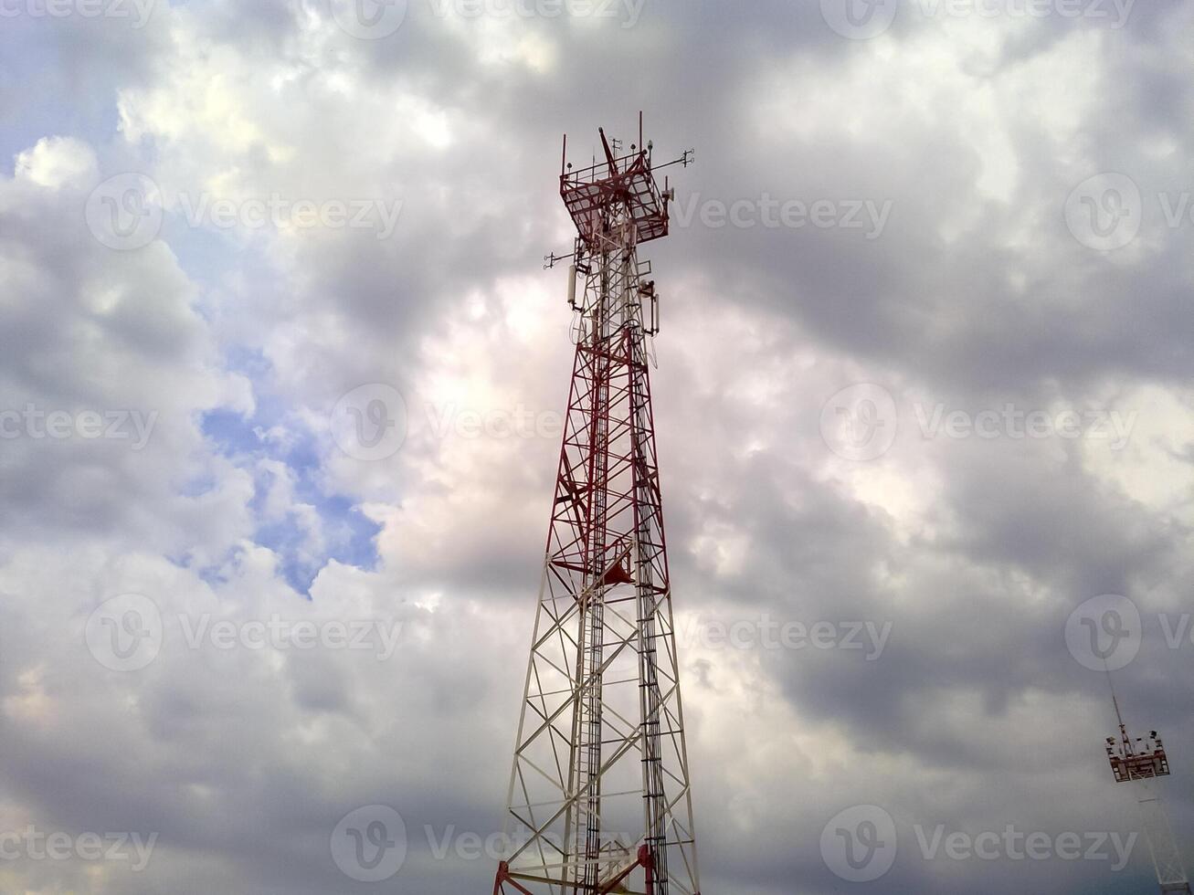Cellular tower. Telecommunication tower. Communication tower against the sky with clouds. photo