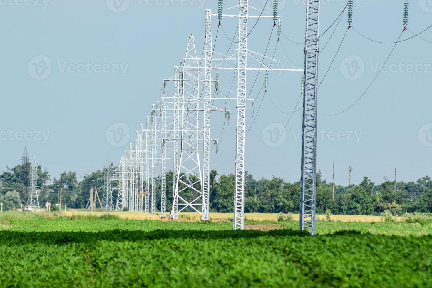 Transmission tower on a background field of soybeans photo