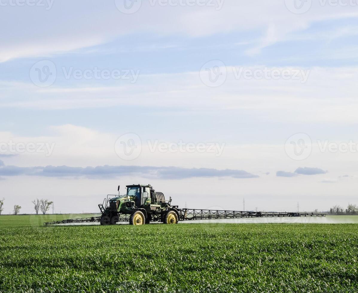 Tractor with a spray device for finely dispersed fertilizer. photo