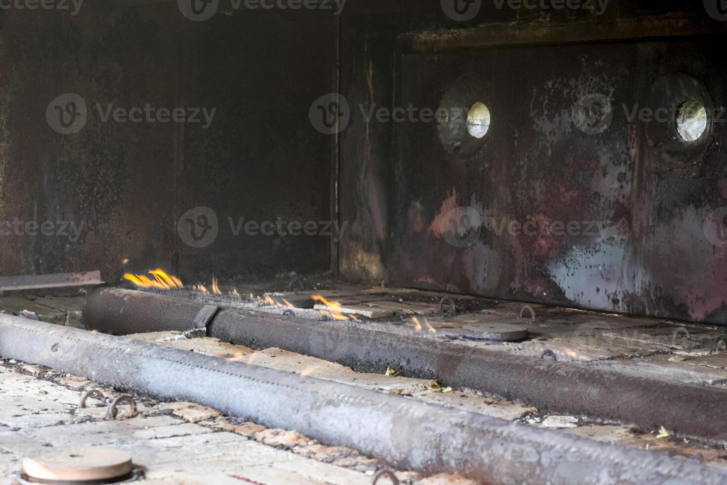 Gas burners at a station for the heating of reservoir fluid. The liquid from the ground is cold and enters the stove where it is heated. Furnace furnace. photo