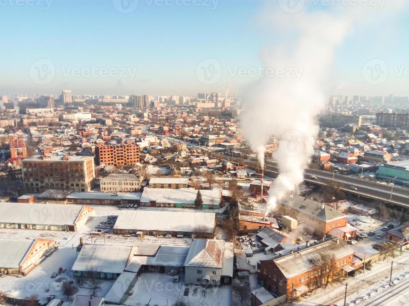 Winter town. Frosty sunny day in the city. Snow on the streets and smoke from the boiler rises. Frost and sun, a wonderful day photo