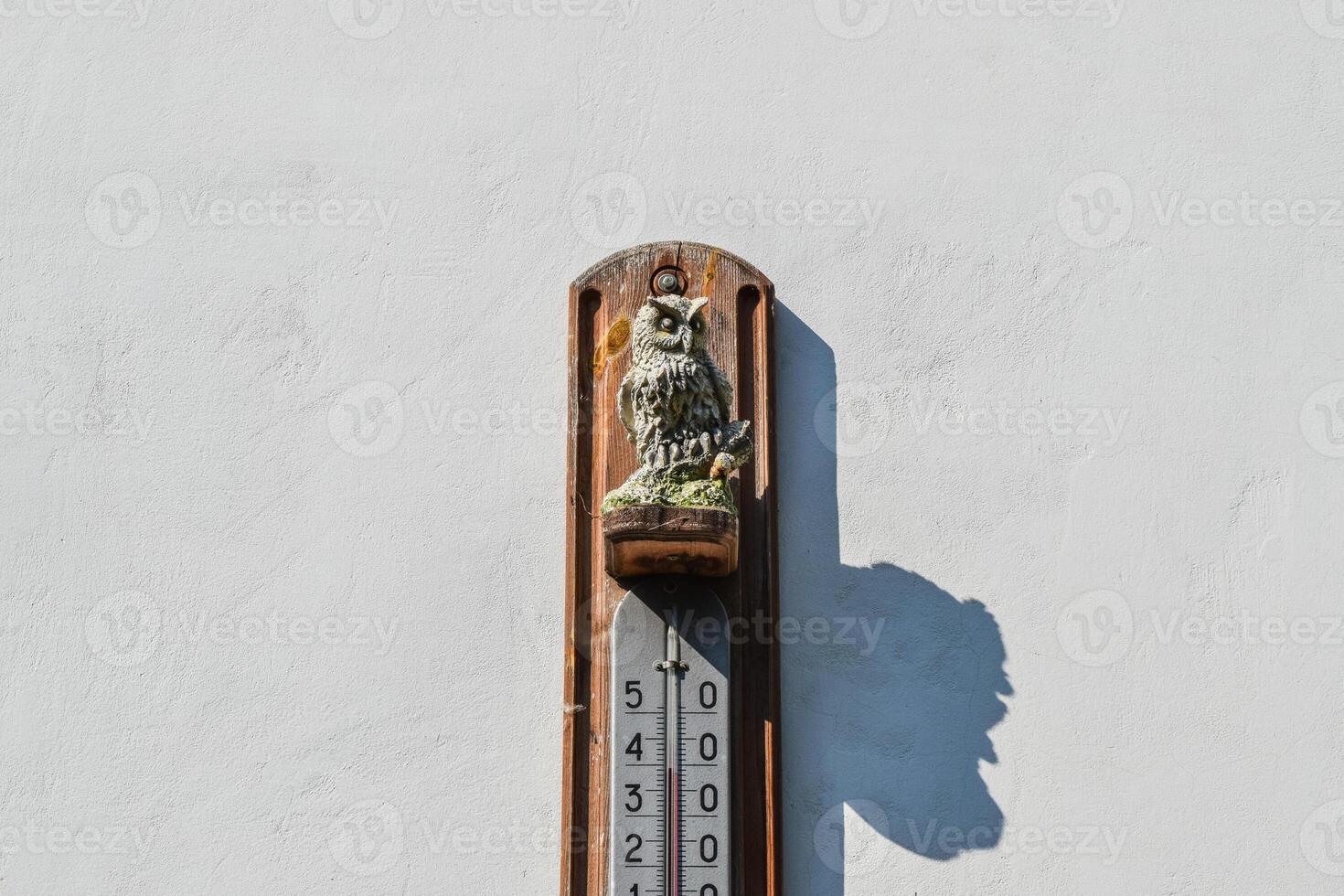 Wall thermometer. A device for measuring the ambient air tempera photo