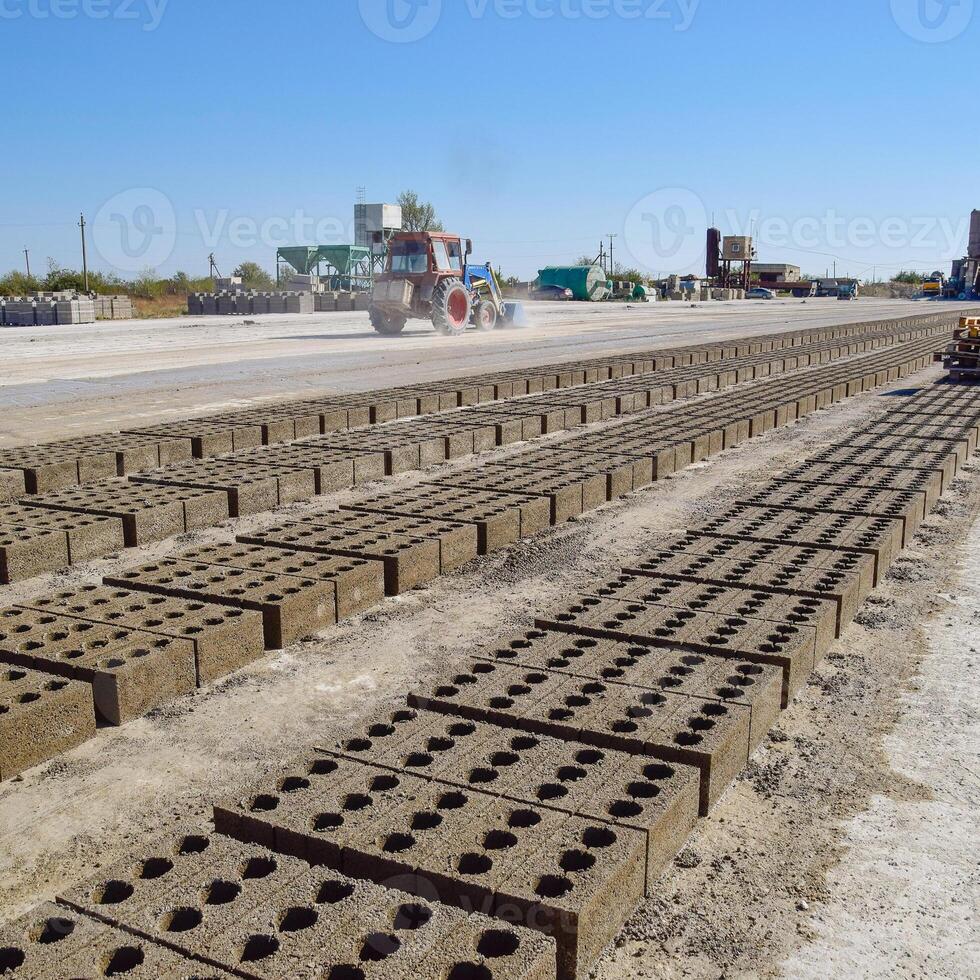 Cinder blocks lie on the ground and dried. on cinder block production plant. photo