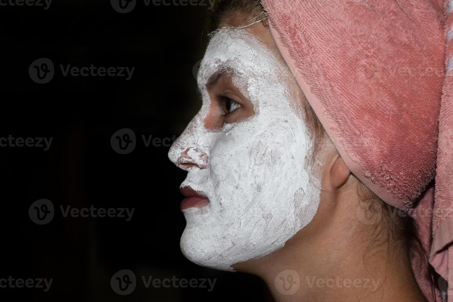 Cosmetic white face mask of toothpaste. Woman in white cosmetic mask photo