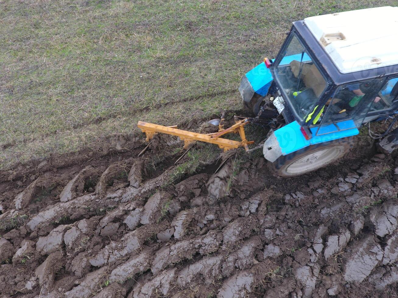 Tractor plowing the garden. Plowing the soil in the garden photo