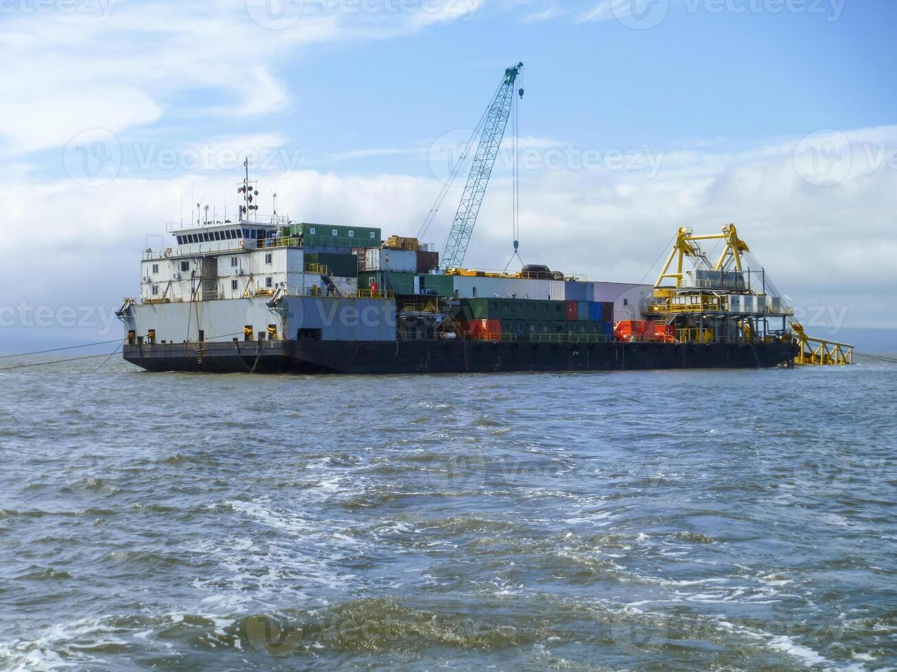 The cargo ship with the crane, the top view. Pipelaying barge. photo