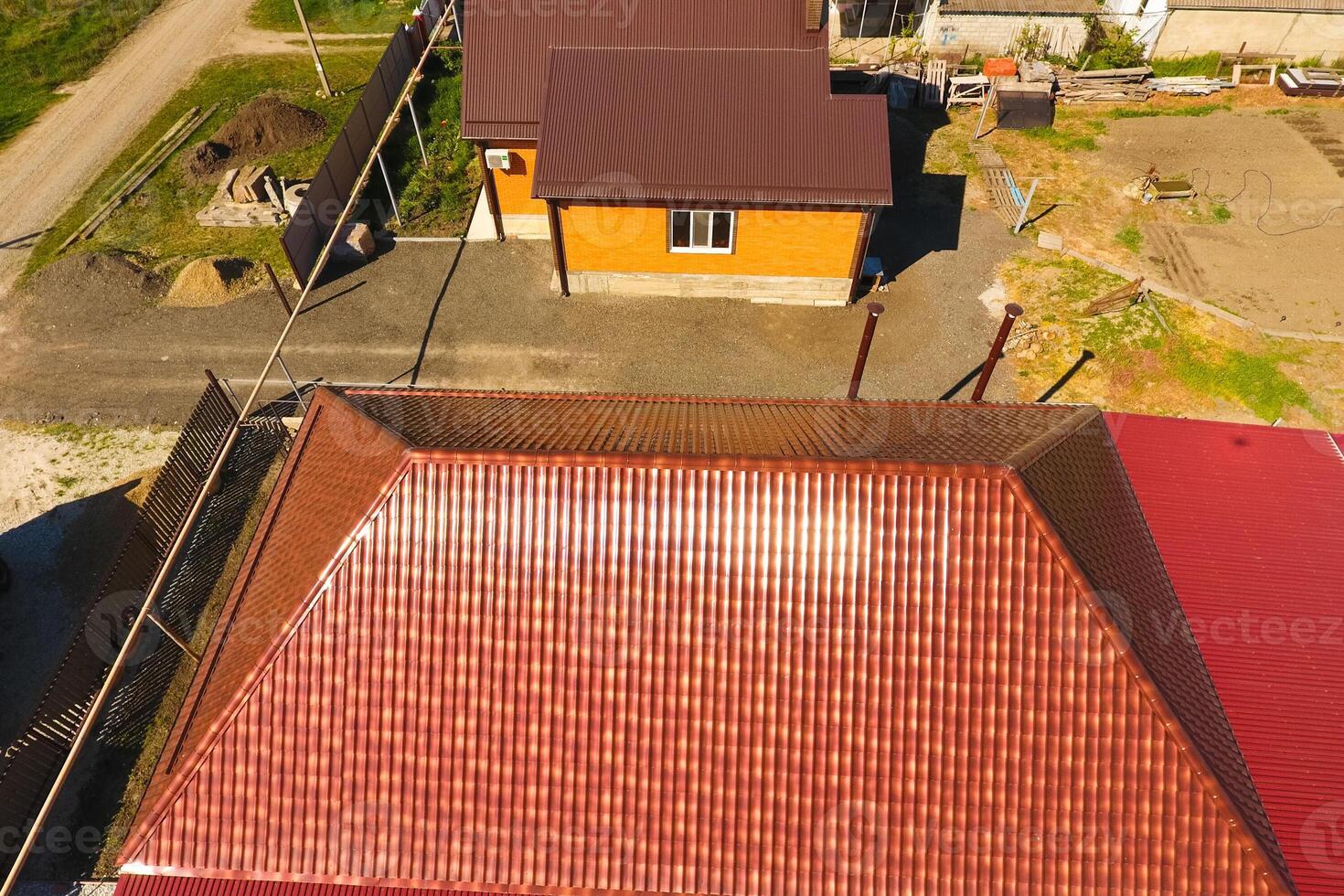A house with a canopy over the courtyard. Roof from corrugated metal profile. Metal tiles. photo