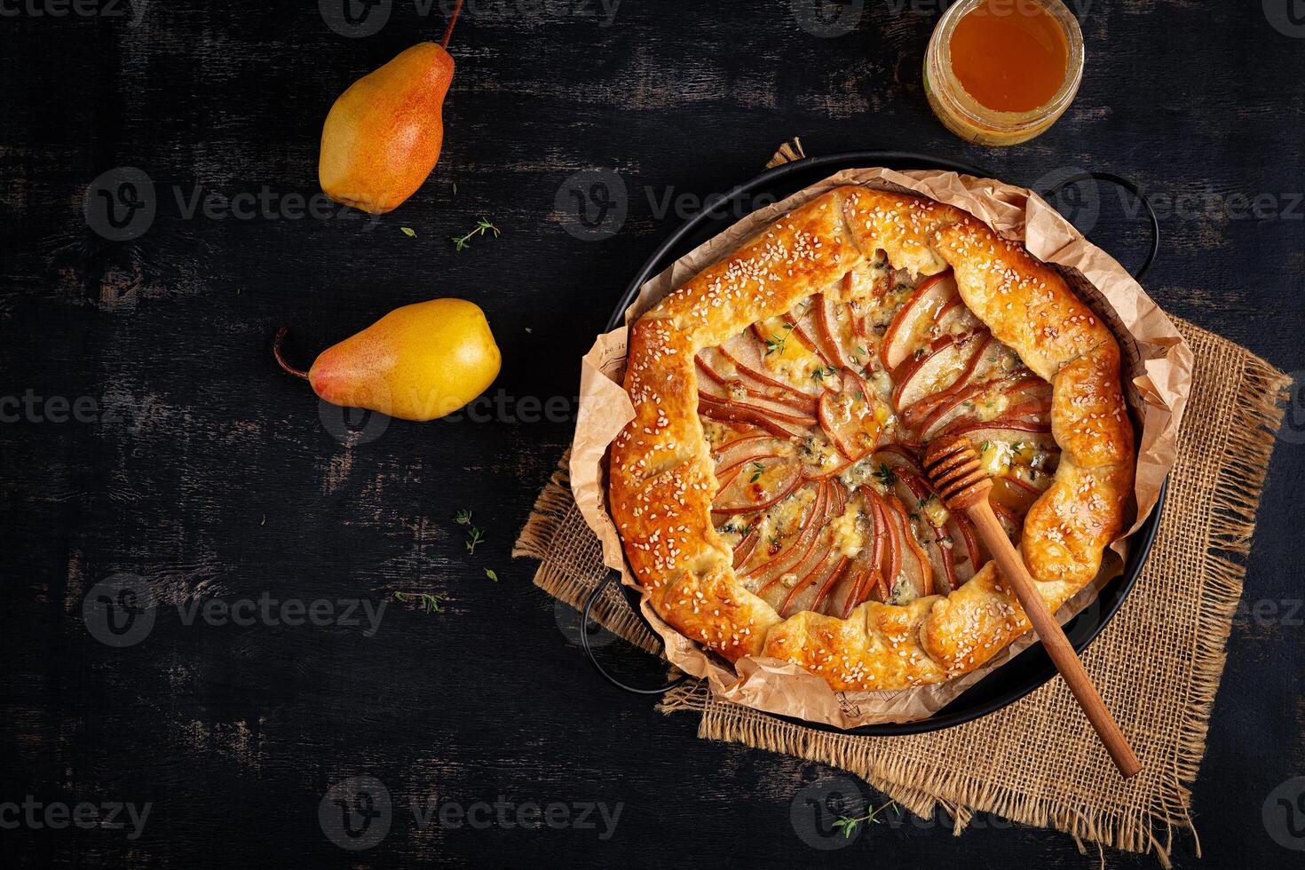 Galette with pear and blue cheese dipped in honey. Healthy eating. Top view photo