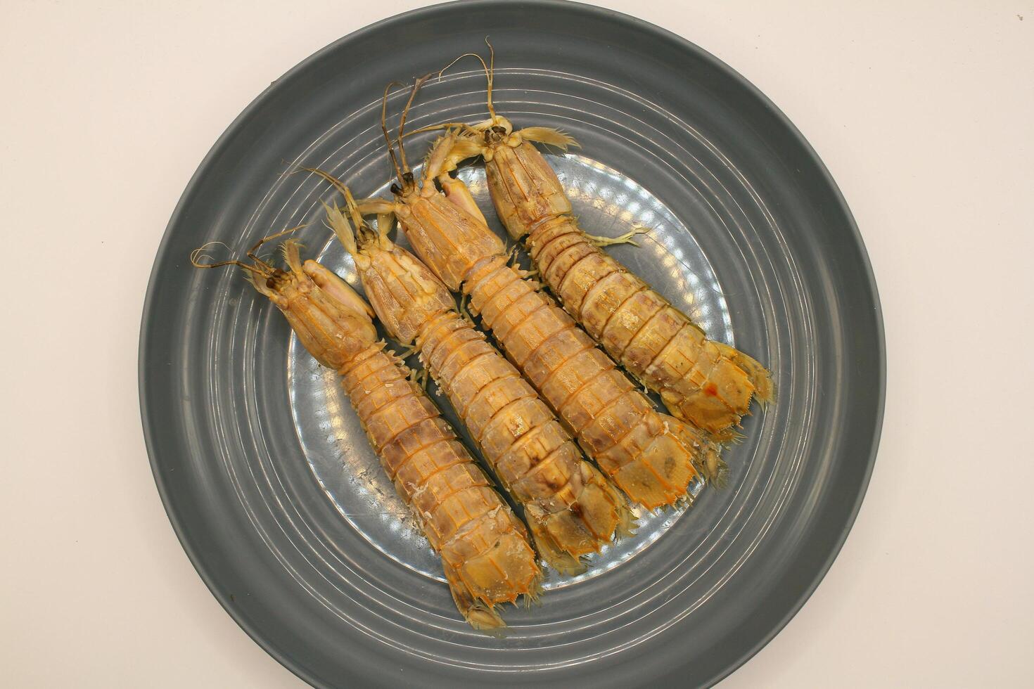 Fresh mantis shrimp on a plate, closeup of photo. photo